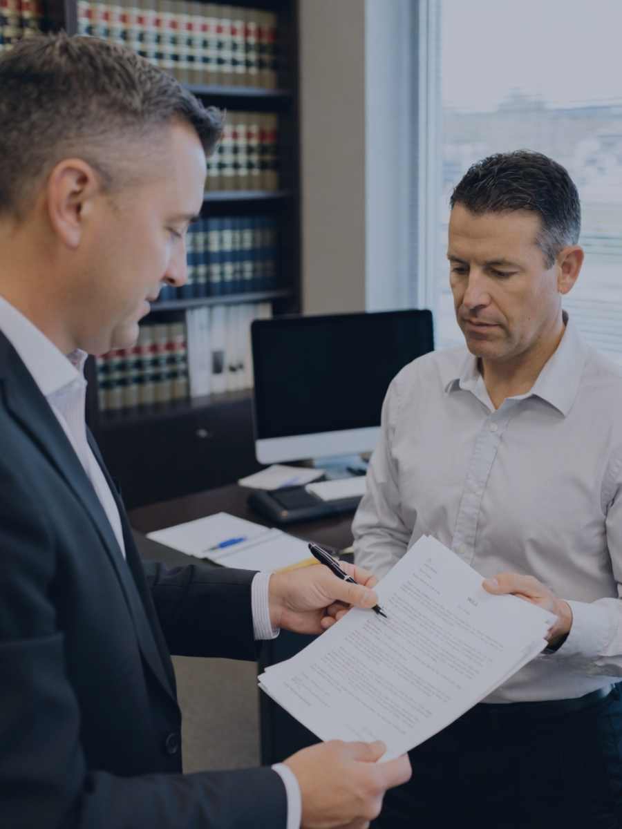 Heredero verificando con su asesor la documentación necesaria para la declaración renta de un fallecido.